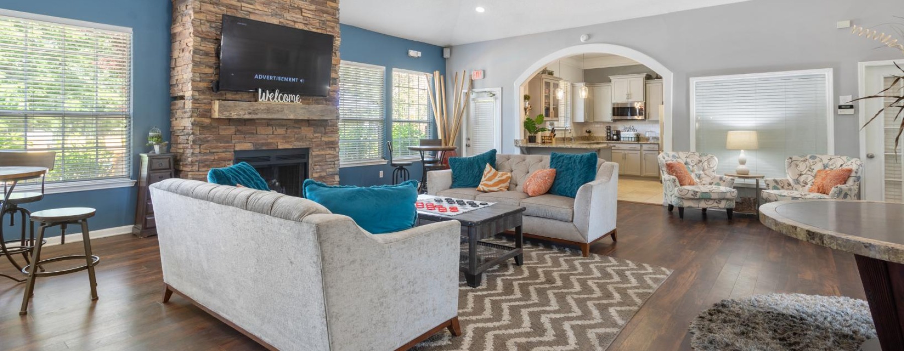 community club house and lounge with a fireplace, ample seating and modern decor