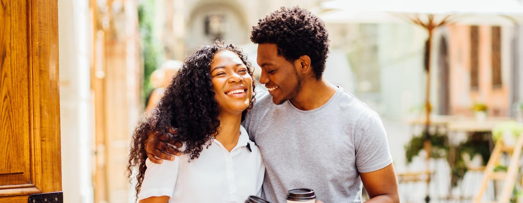 a man and woman holding drinks