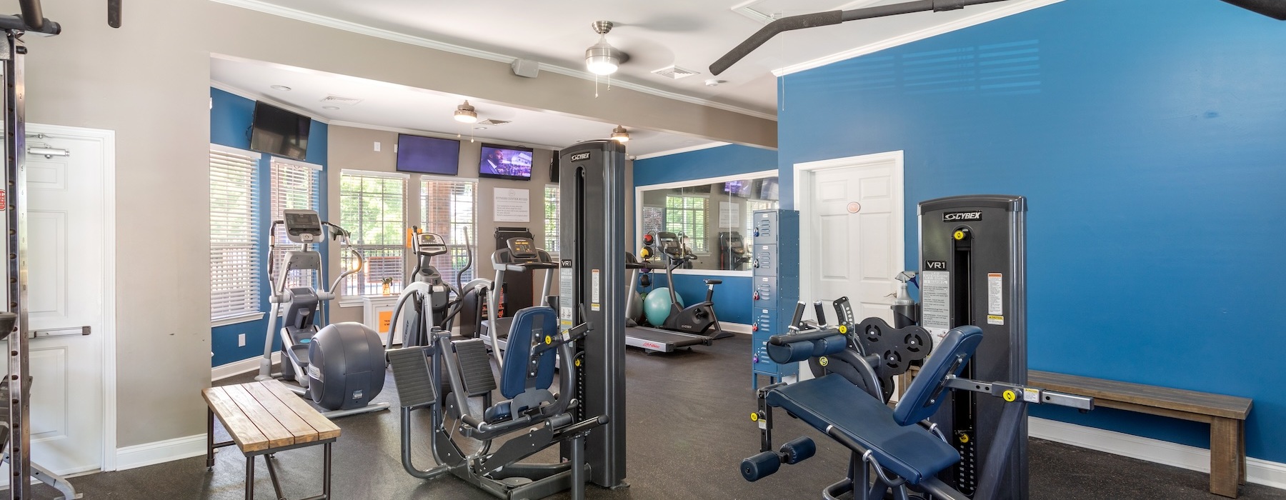 fitness center with rows of treadmills and modern style flooring