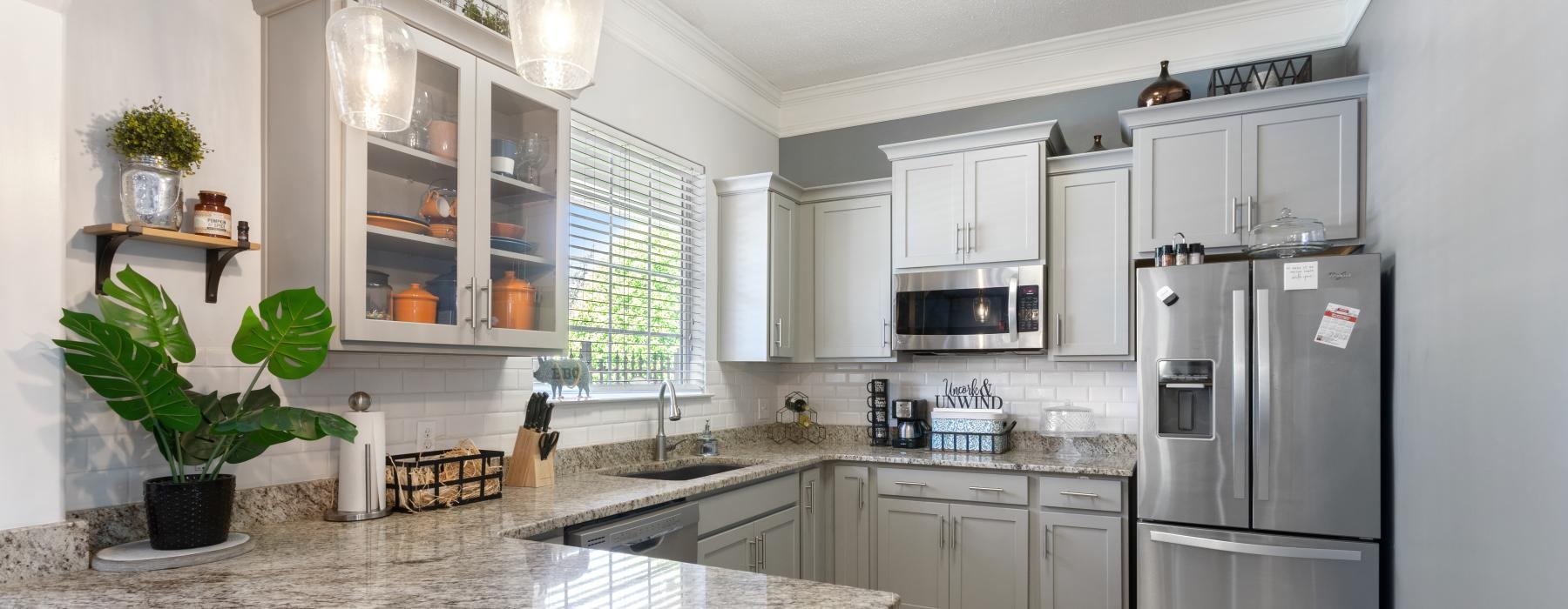 a kitchen with marble counters